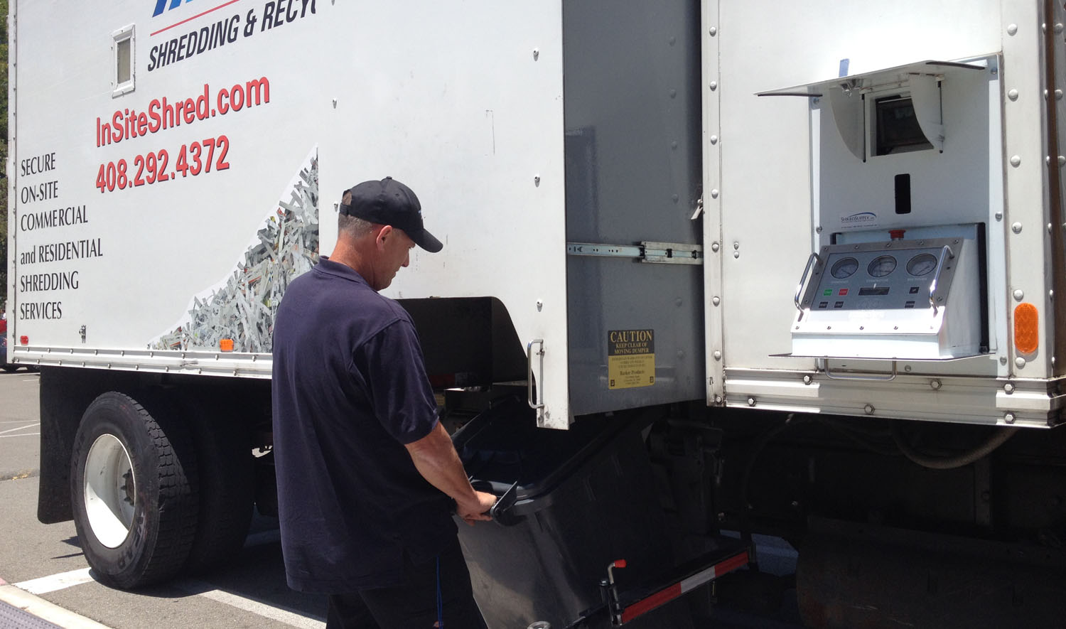 on site shredding service - loading paper bins onto truck