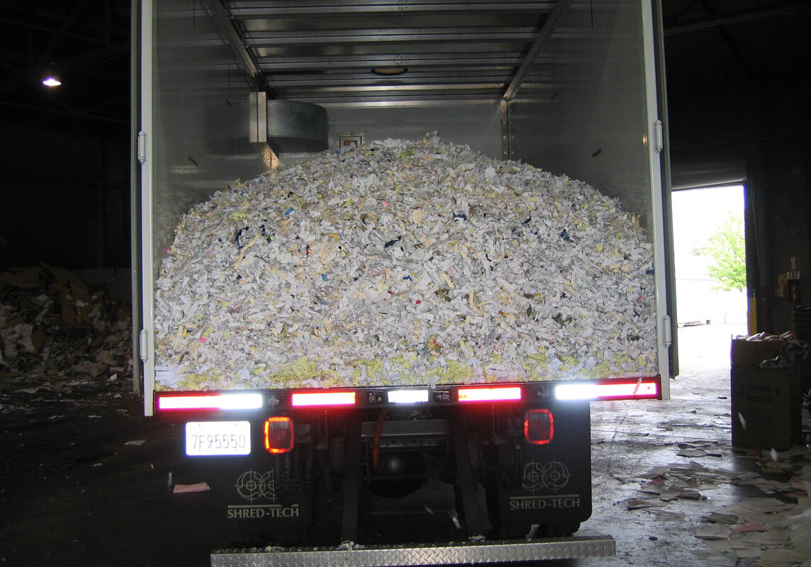 Mobile shredding truck dumping paper at recycling facility