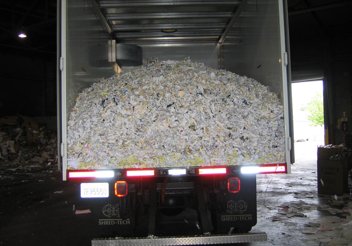 Mobile shredding truck dumping paper at recycling facility Mobile shredding truck dumping paper at recycling facility