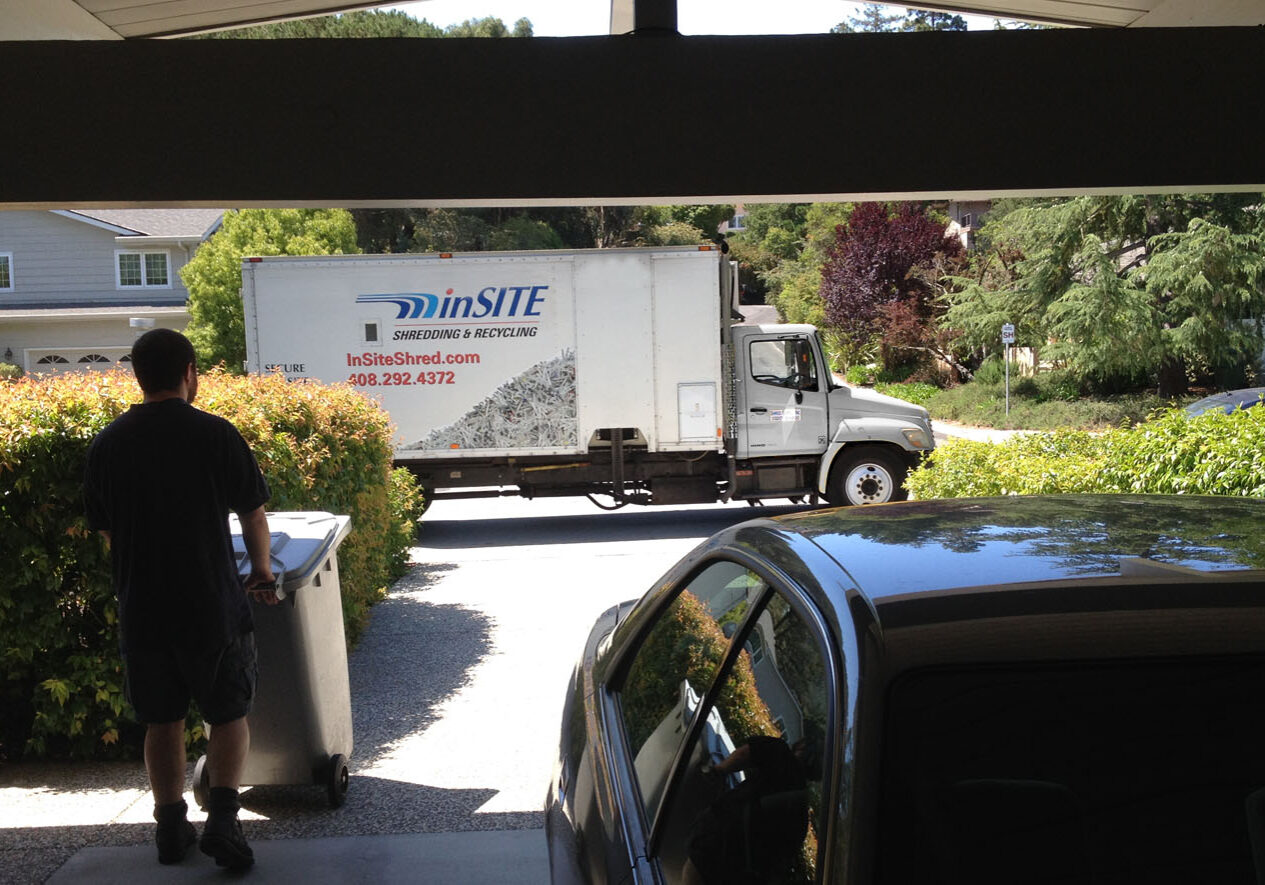 Residential on site shredding service walking out to truck Residential on site shredding service walking out to truck
