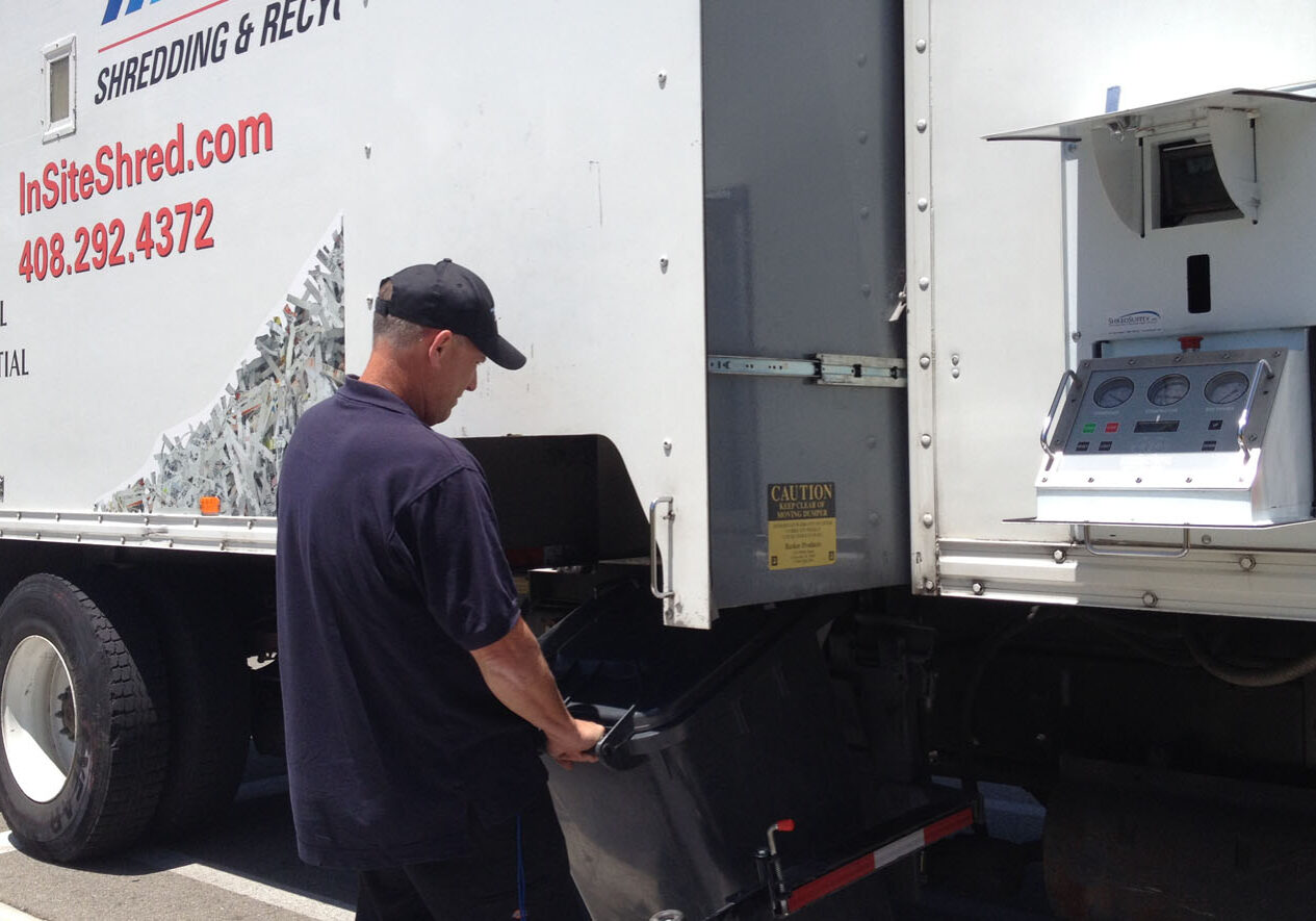 on site shredding service - loading paper bins onto truck